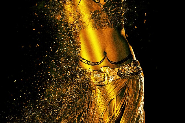 An image showcasing a graceful belly dancer, adorned in vibrant, flowing silk garments, gracefully moving to the hypnotic beats of Arabic music