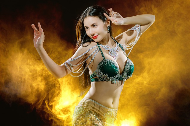 An Image With A Vibrant, Energetic Belly Dancer Gracefully Executing A Mesmerizing Hip Drop, Surrounded By Swirling Silk Veils, As The Glow Of Golden Lights Illuminates Her Every Move