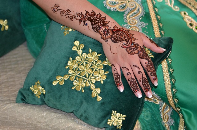 An Image Capturing A Dancer'S Hands Adorned With Intricate Henna Designs, Holding A Vibrant Silk Veil