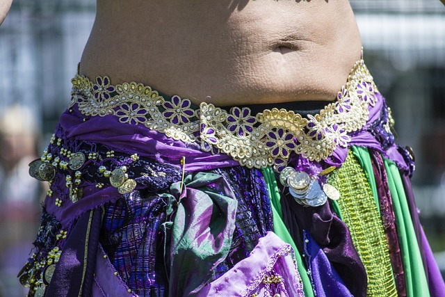 An image capturing the fluidity of a belly dancer's body, as their graceful undulations seamlessly connect each movement
