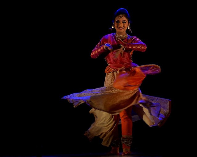 An Image Capturing The Determination Of A Belly Dancer, Gracefully Overcoming Challenges In A Vibrant Studio