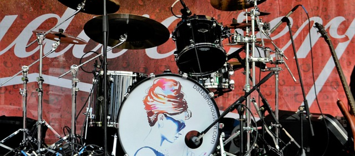 An image showcasing the vibrant chaos of a drum solo, capturing the drummer's intense focus and fluidity